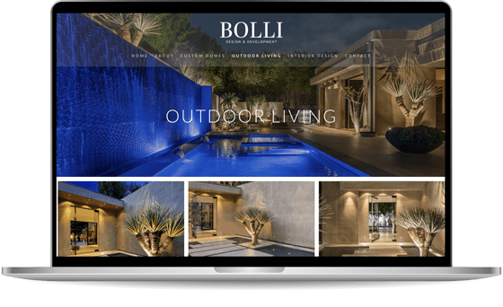 A laptop displaying a website for Bolli Design & Development. The homepage features images of outdoor living spaces, including a pool with surrounding modern architecture and landscaping.