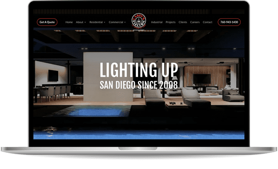 Laptop screen displaying a website with a modern interior design image and text, "Lighting Up San Diego Since 2008." The website features navigation links including About, Residential, Commercial, and more.